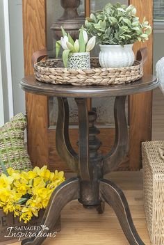 a table that has some flowers on it and two baskets with yellow flowers in them