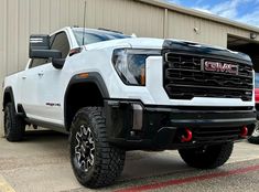 a white truck parked in front of a building