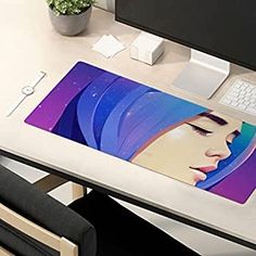 a woman's face is shown on the back of a mouse pad that sits on a desk next to a computer