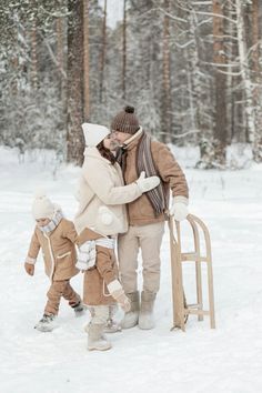 a woman and two children walking in the snow