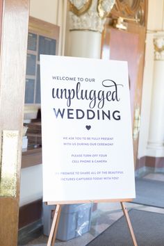 an unplugged wedding sign in front of a door