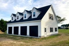 a two story white house with black shutters