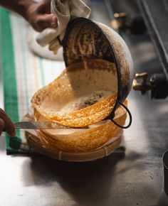 a person cutting bread with a large knife