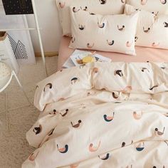 an image of a bed that has been made with flamingos on the sheets and pillowcases