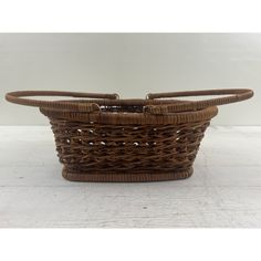 a brown basket sitting on top of a white floor