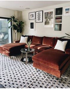 a living room filled with furniture and pictures on the wall