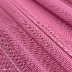 pink fabric textured with small holes on the top and bottom, as well as other material