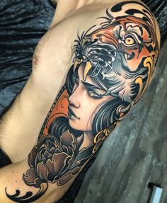 a woman with a tiger head tattoo on her left arm and half - sleeved body