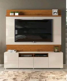 an entertainment center with a flat screen tv mounted on the wall