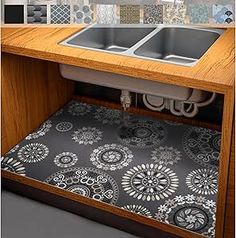 a kitchen sink under a counter with an area rug on the bottom and underneath it