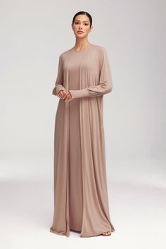 Introducing the Jenin set in Mink - a luxurious pairing of a sleeveless maxi dress and an open abaya. Made from buttery soft jersey fabric, this set exudes elegance and comfort. With thumbholes and a sleek design, it's the elevated basic your wardrobe needs. Model is 5'7" and is wearing size XS/58". White Dress Formal, Nikkah Dress, Dresses Flowy, Open Abaya, Jersey Hijab, Hijab Pins, Engagement Dresses, Kids Outerwear, Basic Dress