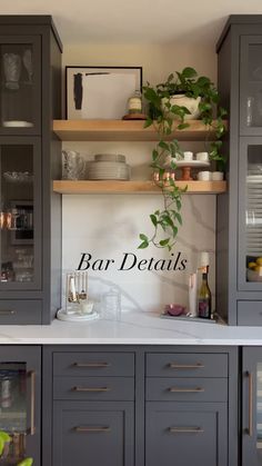 a kitchen with gray cabinets and white counter tops