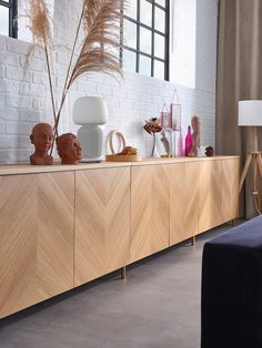 a large wooden cabinet with vases and other decorative items on it's sides