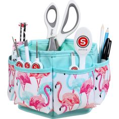 the flamingo pencil holder has scissors, pens and markers in its pocket on it