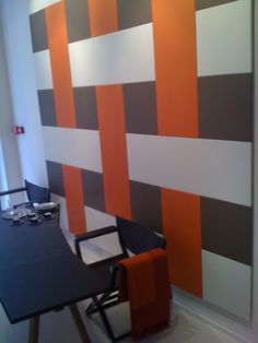 an office with orange and grey striped walls