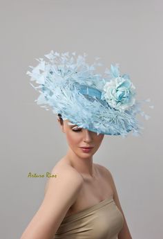 "From my 2024 Collection This pretty baby blue Disk hat is made of sinamay. Brim measures about 14\" across, embellished with Turkey feathers and 2 Custom made Silk roses with crystals. Seated on a baby blue headband. All my hats are hand made to order, please allow 1-2 weeks, if this is a rush order please contact me before ordering. All sales are final." Royal Ascot Ostrich Feather Fascinator, Ostrich Feather Mini Hat For Royal Ascot Races, Ostrich Feather Mini Hats For Races, Royal Ascot Mini Hats With Ostrich Feathers For Races, Kentucky Derby Costume Hats With Feather Trim, Ostrich Feather Hat For Royal Ascot Races, Light Blue Headpieces For Royal Ascot, Blue Feather Trim Mini Hat For Kentucky Derby, Blue Mini Hat With Feather Trim For Kentucky Derby