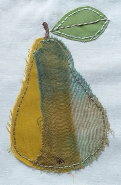 a close up of a piece of fabric with a pear on it's side