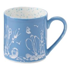 a blue and white coffee mug with sea life on it