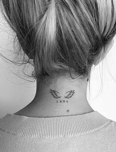 a woman's neck with a small tattoo on the back of her left side