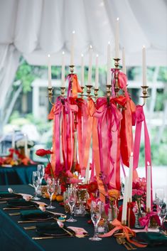 a table topped with lots of tall candles