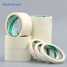 three rolls of masking tape sitting next to each other