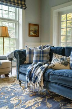 a living room filled with blue couches and pillows