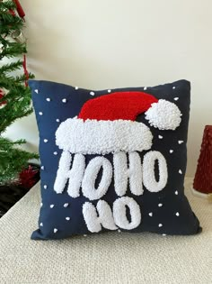 a christmas pillow with the word ho hoo on it and a santa's hat