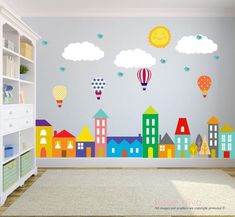 a child's room decorated with colorful wall decals and balloons in the sky