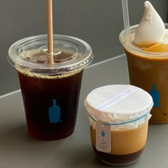 three different types of drinks on a table