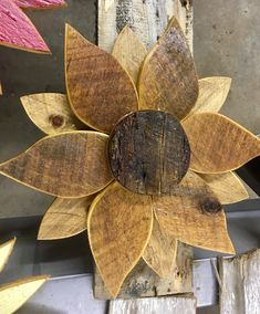 a wooden sunflower sitting on top of a piece of wood next to other pieces of wood