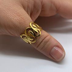 "**Elevate Your Style with Our 18K Gold Plated Irregular Unique Ring 🌟 **Unique Elegance This 18K gold plated irregular unique ring stands out with its wavy pattern and chunky design. Its distinctive style makes it a striking accessory that adds flair to any outfit. 💍 **Dainty Comfort Crafted for comfort, this open ring with its irregular shape offers a unique and comfortable fit on any finger. It's a versatile piece that you can wear effortlessly. 🎁 **Ideal Christmas Gift Whether you're looking for a Christmas present or a special gift for her, this handmade gold ring is an excellent choice. Its craftsmanship and uniqueness will make her holiday season extra special. ⭐ **Why Choose Our 18K Gold Plated Irregular Unique Ring - **Striking Design A statement piece that exudes confidence. - Gold Wavy Rings For Anniversary, Gold Wavy Rings For Gifts, Wavy Gold Rings For Gift, Adjustable Unique Yellow Gold Snake Ring, Luxury Modernist Yellow Gold Signet Ring, Luxury Modernist Gold Rings, Luxury Modernist Yellow Gold Rings, Modernist Hand-cast Jewelry Ring, Handmade Gold Ring