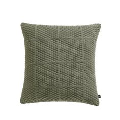 a green knitted pillow on a white background