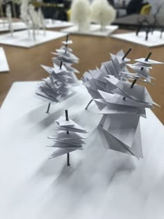 several paper sculptures are sitting on the table