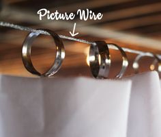 two wedding rings are hanging on a clothes line