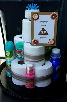 several rolls of toilet paper are stacked on top of each other in front of a sign