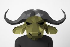 a man wearing a paper mask with horns on it's head and an origami bull face