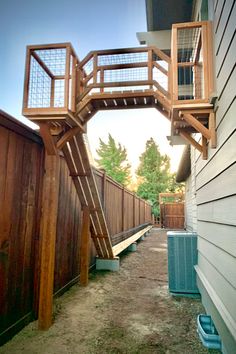 a wooden staircase going up the side of a house