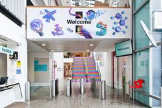 the entrance to a children's hospital is decorated with colorful signs and artwork on it