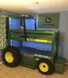 there is a bunk bed made to look like a tractor with two large tires on it