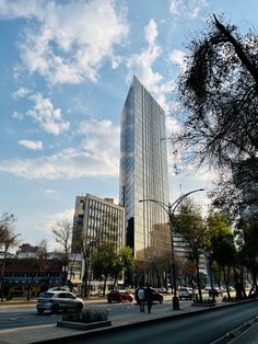 a tall building sitting next to a street filled with traffic