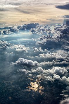 an aerial view of the sky and clouds with sunbeams in it's center