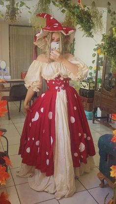 a woman in a red and white dress taking a selfie