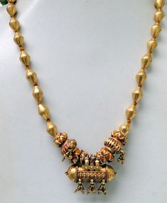 "A rare very old tribal piece of history from India. A tube shape pendant used to put good luck messages into this container for long life perspective and save from evil eye strung together with gold beads & tassel Followed by tube-shaped wax filled 22 Karat gold beads. Making this piece of jewelry highly sort after tribal or fashion statement as it's featured in vogue. Total length-50 cm(19.5\") we can adjust length, size of pendant -4/2. cm, total weight-66 grams(2.31 ounce), Net gold weig Good Luck Messages, Gold Amulet, Life Perspective, Coral Jewelry Set, Beads Making, Fancy Jewelry Necklace, Bridal Jewelry Vintage, Antique Jewellery Designs, Pearl Necklace Designs