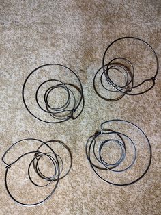 four circular metal objects sitting on the floor next to each other, all connected together