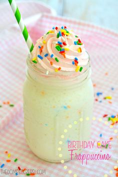 a birthday cake in a mason jar with sprinkles and a striped straw