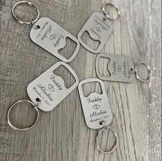 six personalized metal key chains with names and date engraved on the front, two for each family member