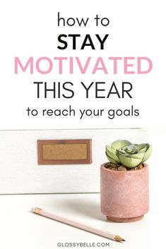 a pink potted plant sitting on top of a desk next to a pencil and eraser