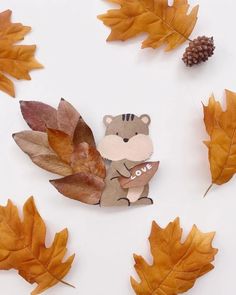 some leaves are laying on the ground next to a bear