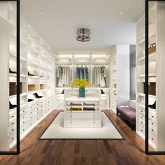 a walk in closet filled with lots of white furniture