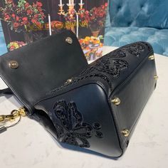 Dolce & Gabbana Medium Sicily Bag In Embroidered Black For Women 10.2in/26cm DG Rep 1:1 Size: 21 x 26 x 12 cm / 8.3 x 10.2 x 4.7 inches (Length x Height x Width) Laser-etched enameled metal plate with logo on the front Top handle and adjustable, detachable strap Storage pocket with zipper featuring a branded slider Metal feet studs on the base Item comes with a branded dust bag Includes dust bag. This product is of the best quality. Sicily Bag, Louis Vuitton Shirt, Soft Bag, Loafer Mules, Metal Plate, Evening Clutch Bag, Girls Bags, Tote Backpack, Sicily